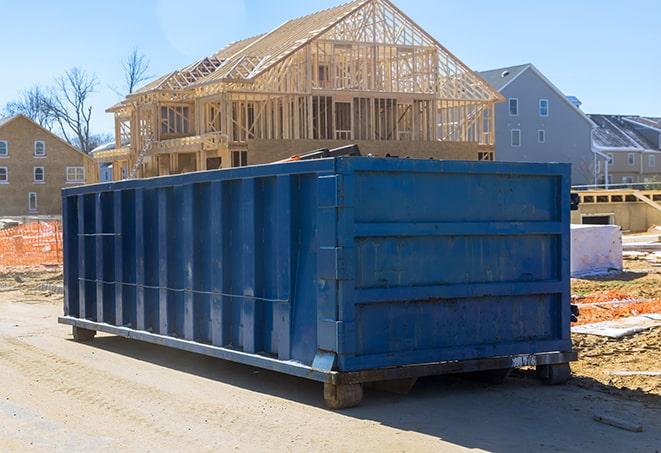 open-top dumpster filled with debris from a remodel